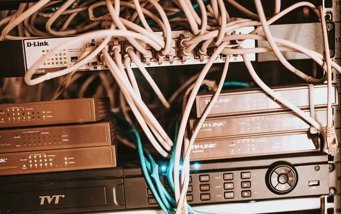 Network equipment and cables organized in a server rack at a modern office environment during the afternoon